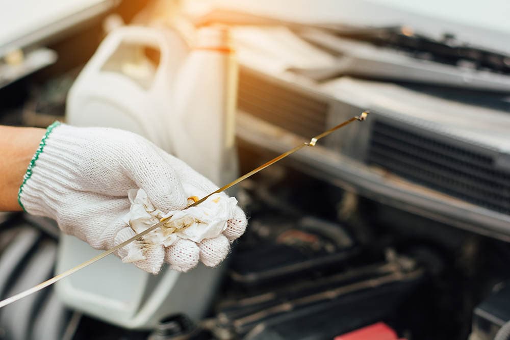 mechanic checking engine oil level