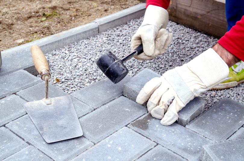 man installing bricks