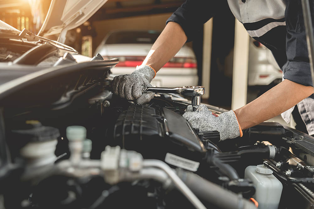 mechanic repairing car engine