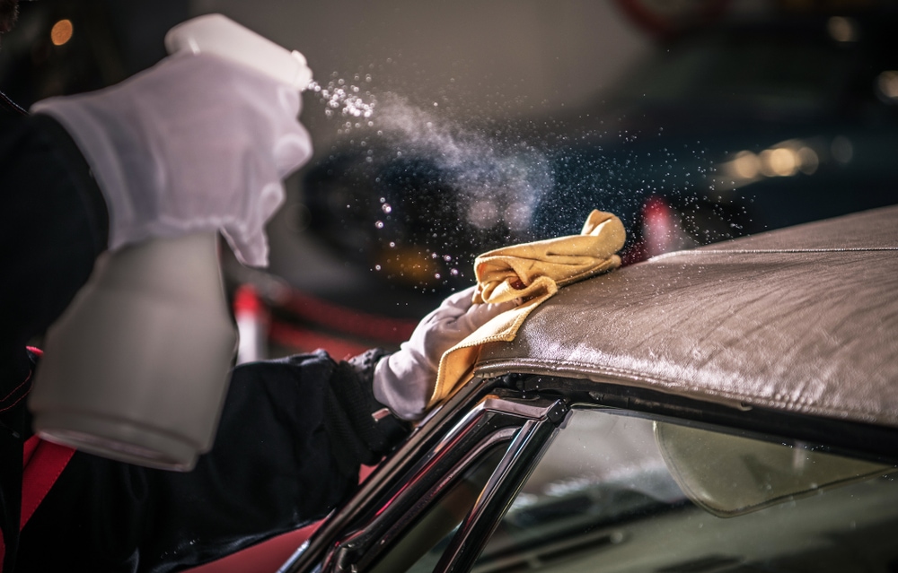 Men Spraying Vinyl Protectant in Car Soft Roof