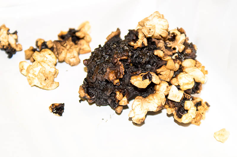 several burned popcorn on white background