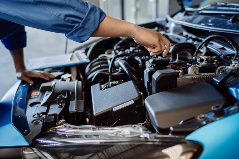 a mechanic checking a worn out car