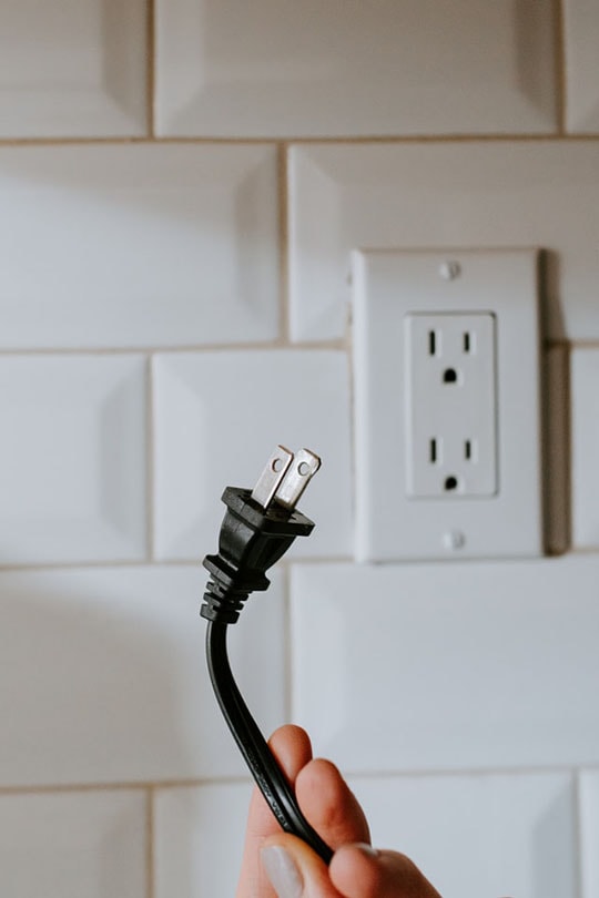 hand holding an unplugged cord
