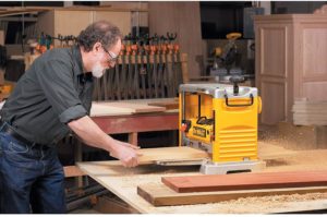 man using DEWALT DW734 Benchtop Planer