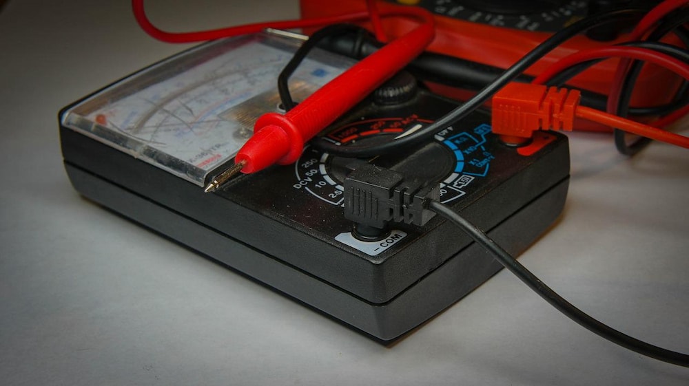 black multimeter on a white surface