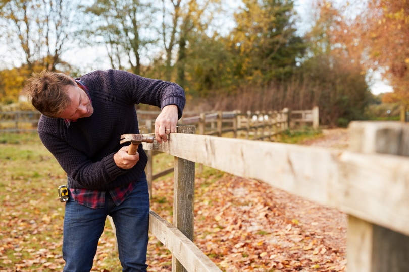 man building fence