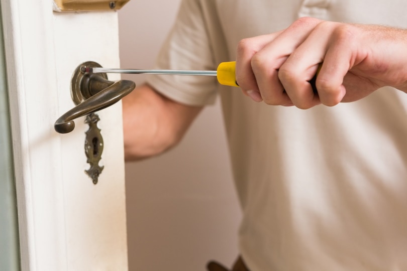 man fixing door knob