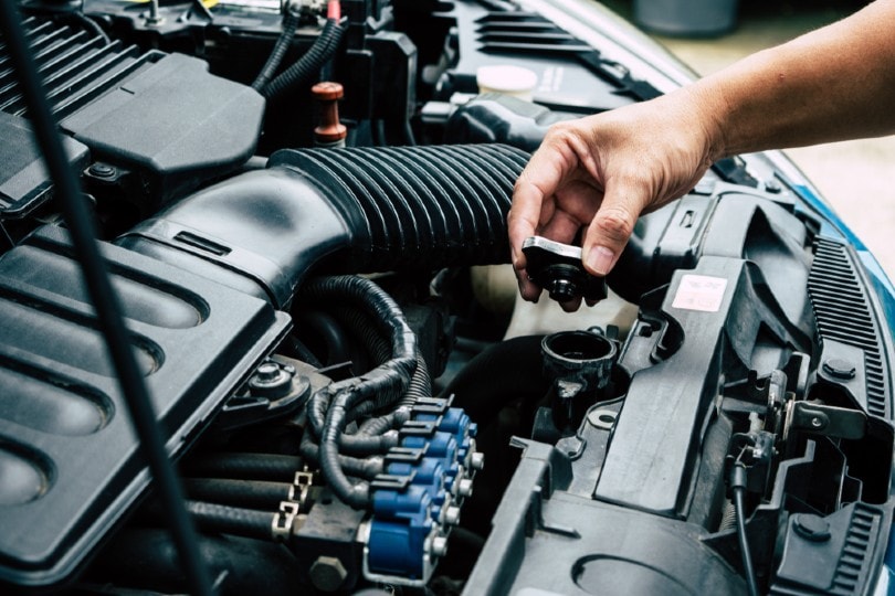 man opening car radiator