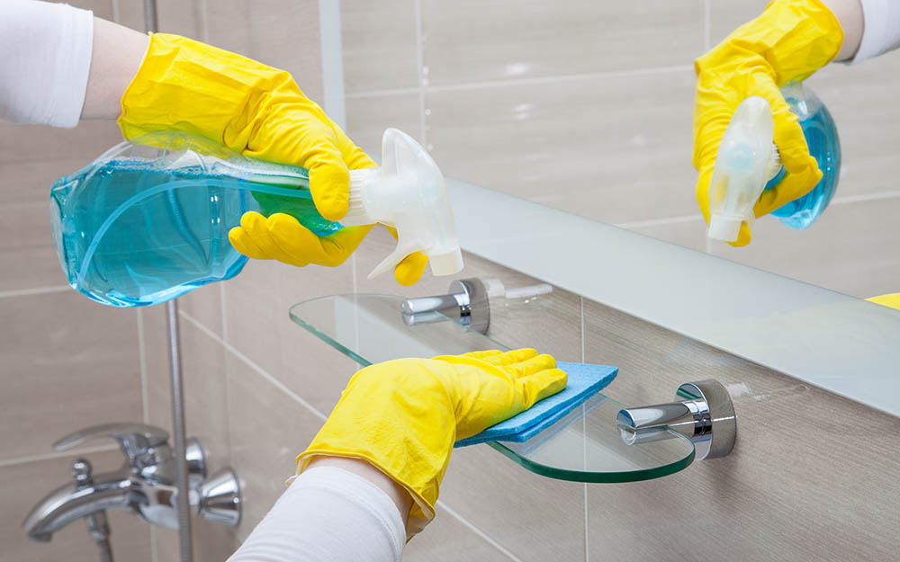 person cleaning the bathroom