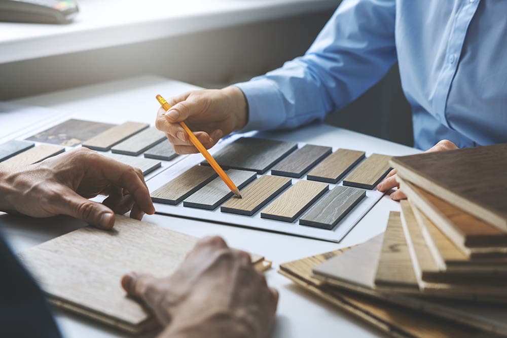 interior designer and client choosing flooring
