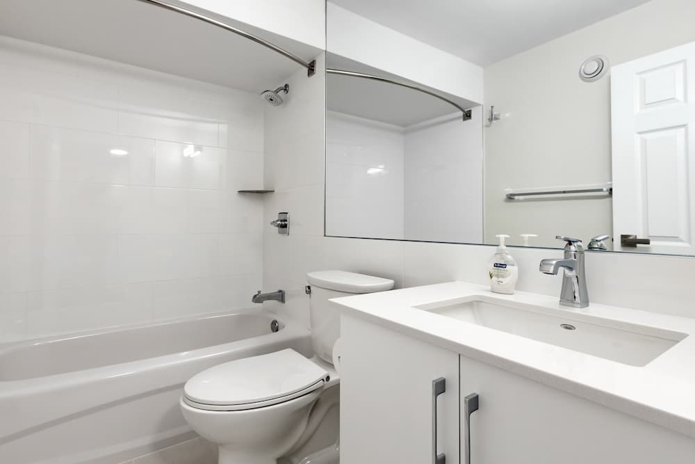 white bathroom with toilet and mirror