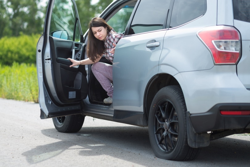 woman looking on flat tire