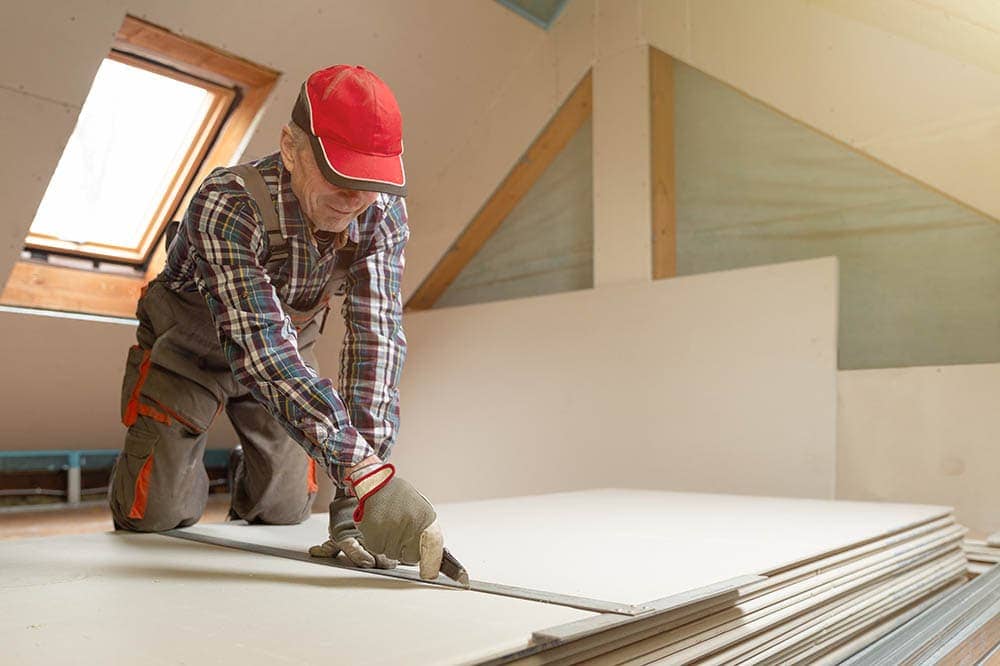 man cutting drywall