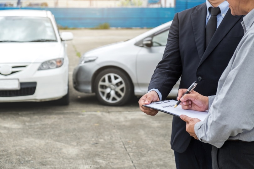 man signing insurance documents