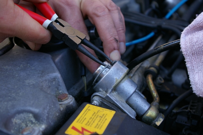 man using snap ring pliers