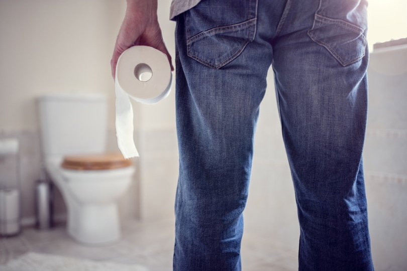 man holding toilet tissue