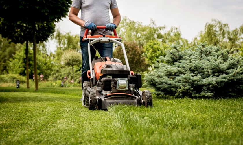 man using lawn mower