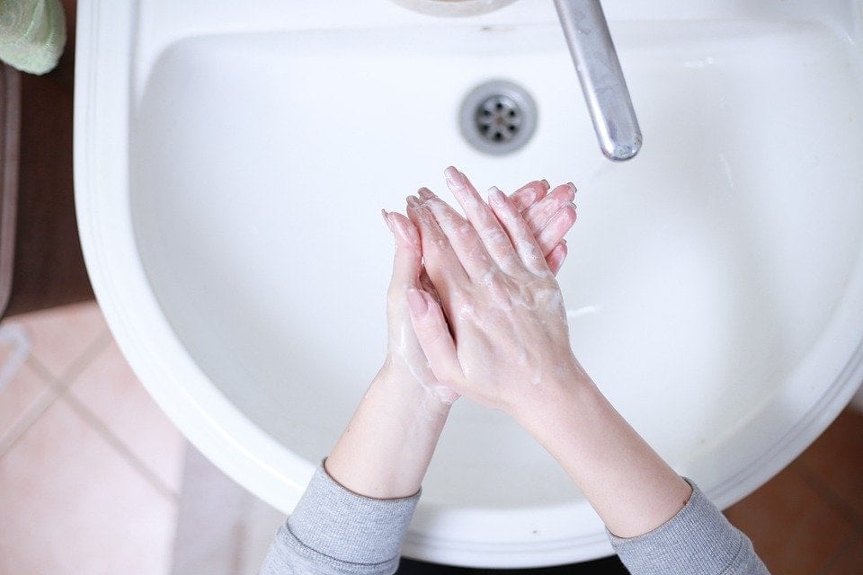 washing hands over sink